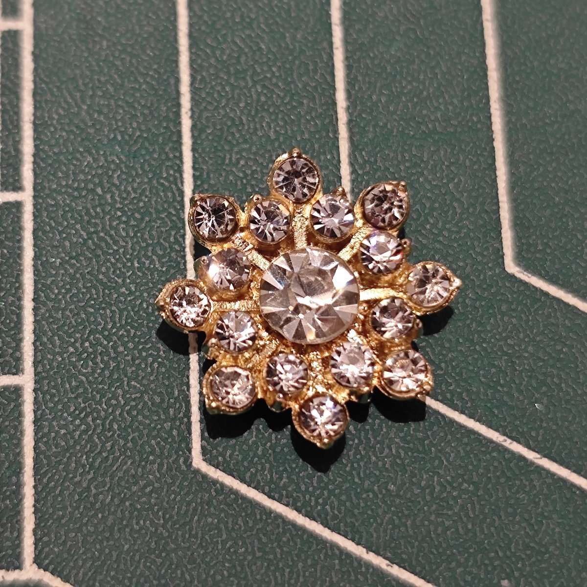 Close-up of Gold-Tone Snowflake Flower Center with Large Center Rhinestone and Clear Accents