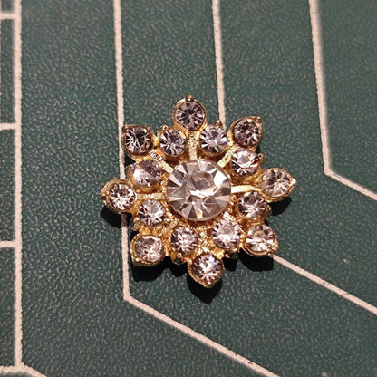 Close-up of Gold-Tone Snowflake Flower Center with Large Center Rhinestone and Clear Accents