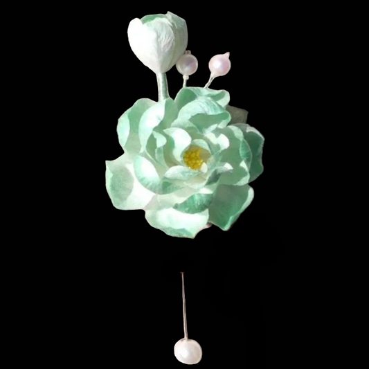 Handcrafted Ronghua green hibiscus brooch featuring a soft velvet texture, yellow stamen, and pearl accents.
