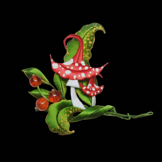 Handcrafted Chanhua brooch featuring thread-wrapped red mushrooms, green leaves with gold accents, and red berries.