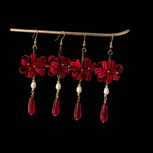 Handcrafted Chanhua thread-wrapped earrings in a red Spider Lily design with white pearls and deep red teardrop drops.