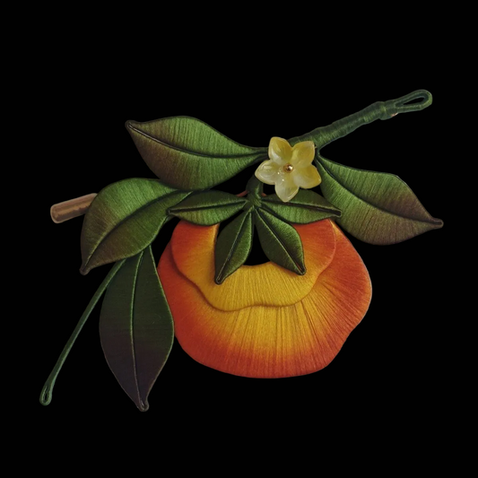 Handcrafted Chanhua persimmon brooch featuring vibrant orange thread-wrapped fruit, green leaves, and a yellow flower.