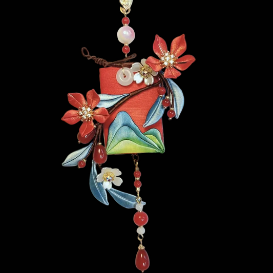 Traditional 3D thread-wrapped decorative charm with red beads and floral accents for home or car decor.
