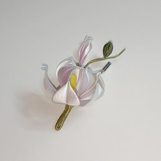 A top-down view of a traditional Chinese silk-thread (Chanhua) floral art piece on a plain background, showing the intricate thread-wrapped details.