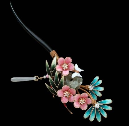 Close-up of Ronghua Three Friends of Winter hairpin showing pink velvet plum blossoms with crystal centers and dark green pine leaf detail