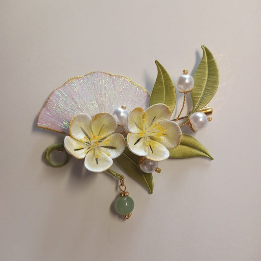 3D botanical pin with a traditional fan and floral design made using artisanal thread-wrapping techniques and jade-colored bead.