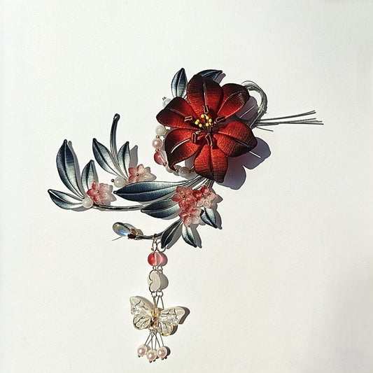 Luxury 3D embroidery floral hair accessory with artisanal thread-wrapped petals in a crimson and black gradient.