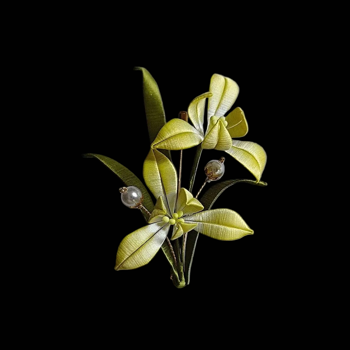 Handcrafted Chanhua orchid brooch featuring white and purple thread-wrapped petals with green leaves.