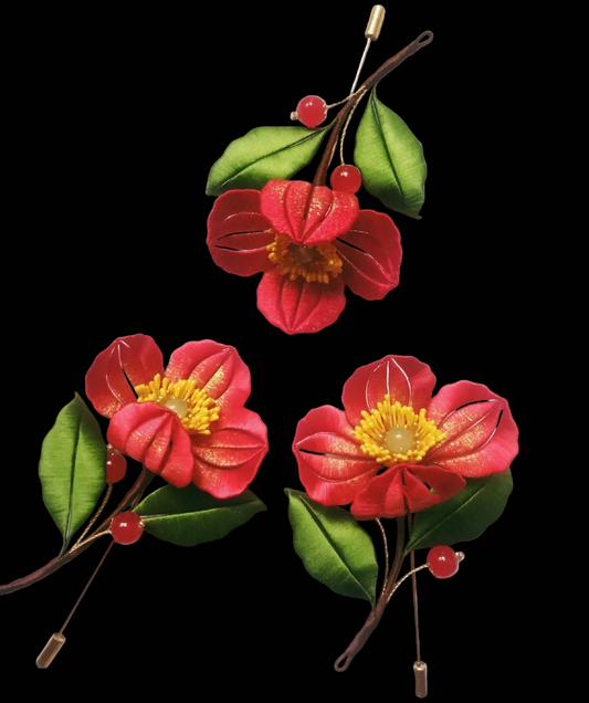 Handcrafted Chanhua red corn poppy brooch featuring thread-wrapped petals with gold accents and green leaves.