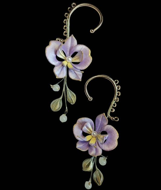Handcrafted Chanhua Moth Orchid ear cuffs featuring thread-wrapped purple petals, golden edges, and dangling floral buds.