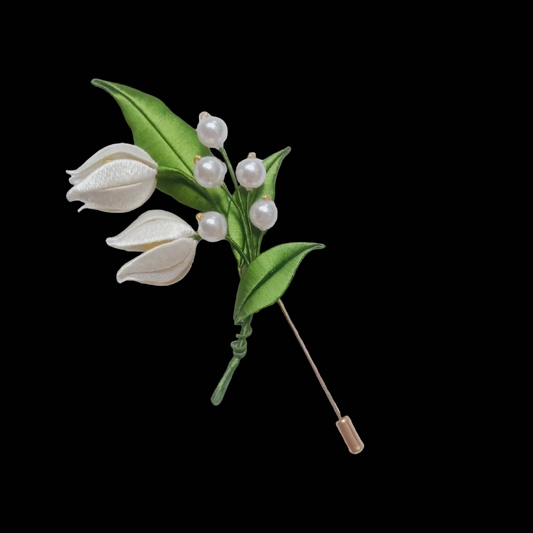 Handcrafted Chanhua Lily of the Valley brooch featuring thread-wrapped white bell flowers and green leaves with pearl accents.