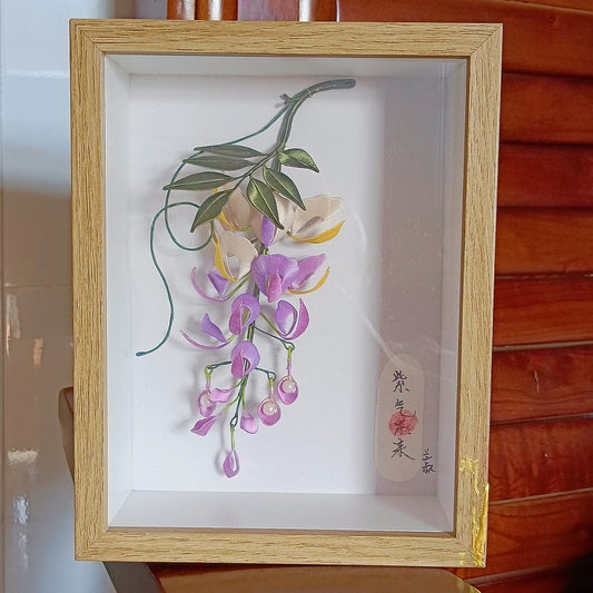 Luxury 3D embroidery floral decor with artisanal silk-thread wisteria blossoms in a shadow box for home interior design.