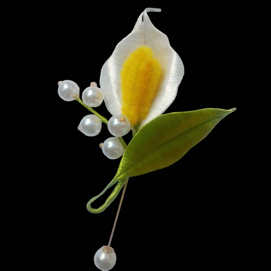 Handcrafted Chanhua Calla Lily brooch featuring a thread-wrapped white flower, yellow center, and green leaf with pearl accents.