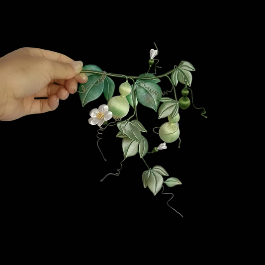 Luxury 3D embroidery art piece of a trailing gourd vine with intricate silk-thread details and winding green tendrils.