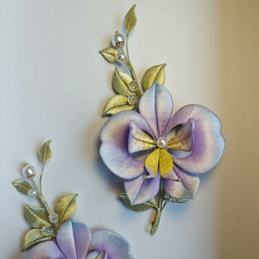 3D floral pin depicting a blooming Phalaenopsis orchid made with traditional artisanal thread-wrapping.