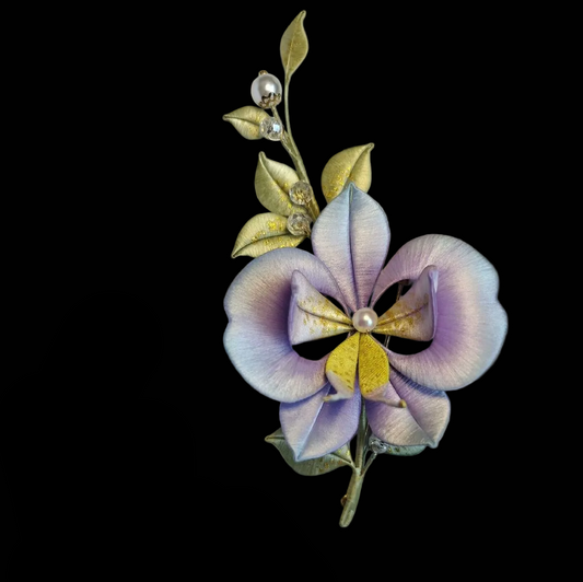 Handcrafted Chanhua Moth Orchid brooch featuring thread-wrapped purple and white petals with an intricate floral center.