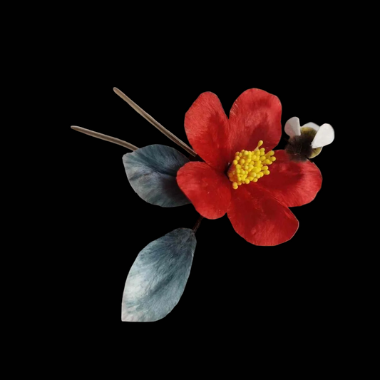 Handcrafted Ronghua red camellia hairpin featuring soft velvet-textured silk petals and a detailed golden stamen.