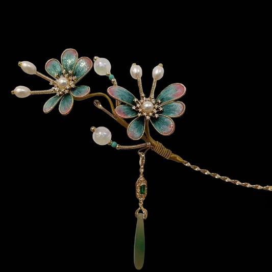 Close-up of turquoise and pink silk velvet flowers with crystal centers and pearls on Ronghua hairpin