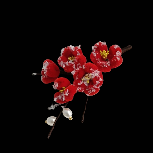 Handcrafted Ronghua Red Plum Blossom pin featuring velvet-textured silk petals with delicate white "snow" accents and pearls.