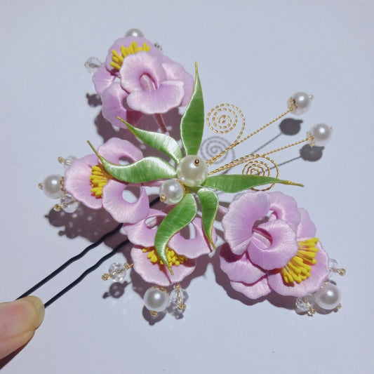 3D floral and butterfly hair accessory made with traditional artisanal thread-wrapping techniques.