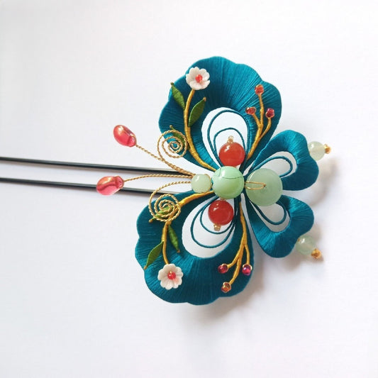 3D artisanal hair accessory depicting a "Multi-Treasure" butterfly made with intricate traditional thread-wrapping.