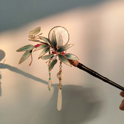 Ronghua handmade bamboo and butterfly hairpin with teal velvet leaves, gold edge trim, iridescent shell disc, crystal and jade pendants, and dark wooden pin, displayed on dark grey fabric