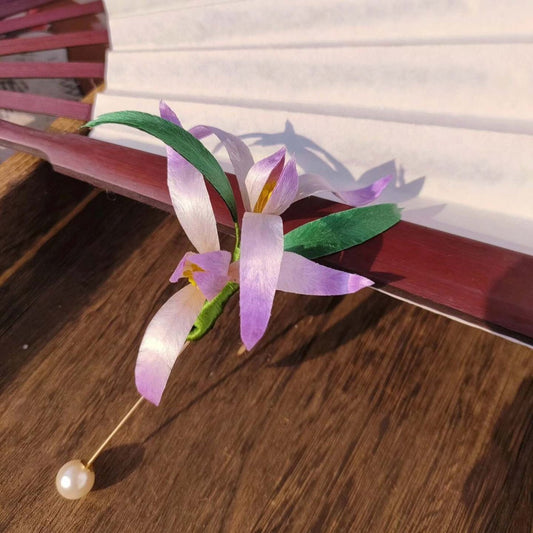 3D silk velvet floral brooch featuring a purple iris blossom made with traditional artisanal Ronghua techniques.