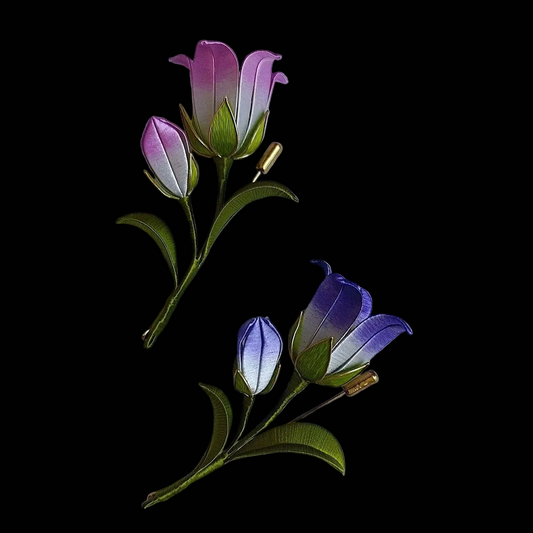 Handcrafted Chanhua bellflower brooch featuring purple and blue thread-wrapped petals with green leaves.