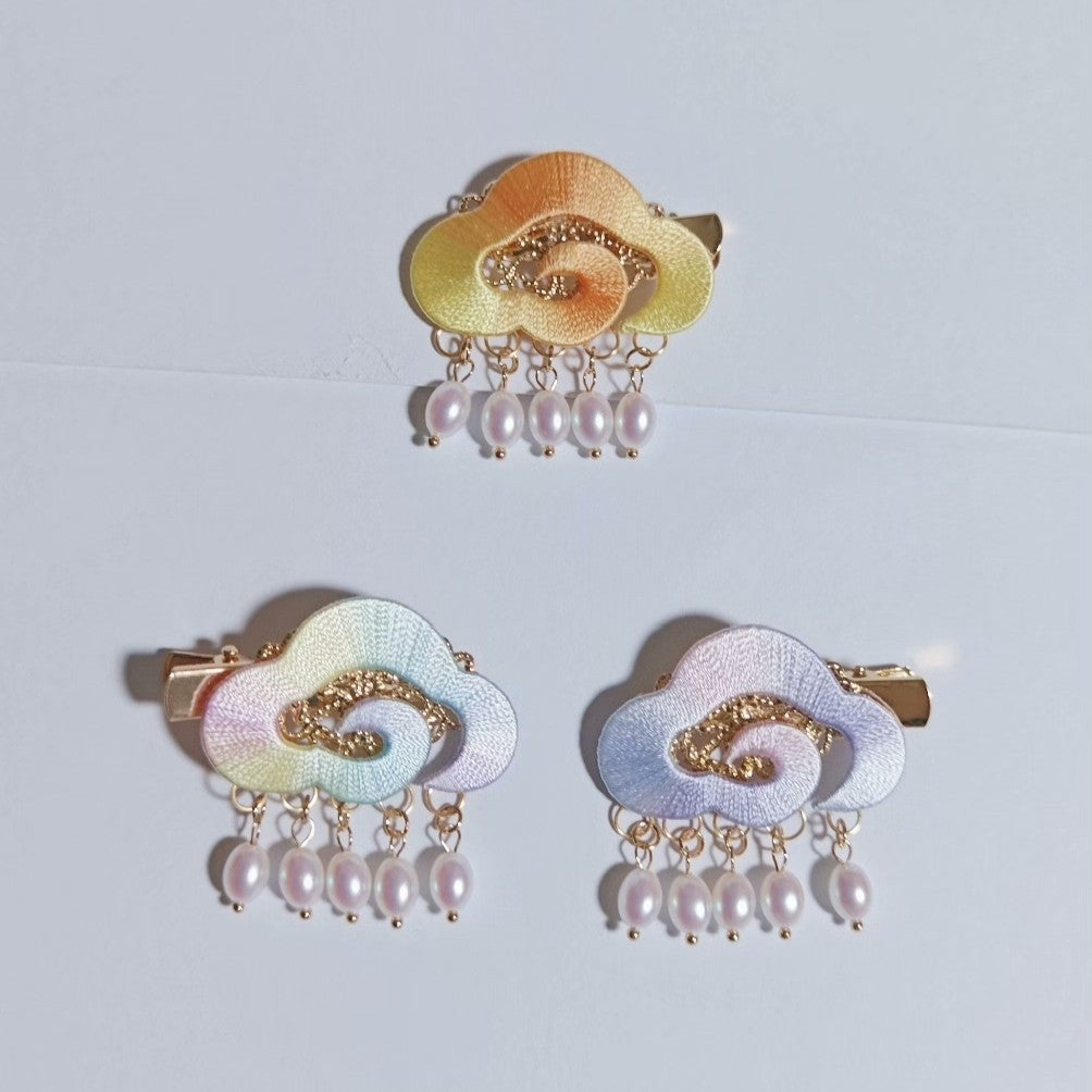 Chanhua handmade cloud hair clips in three color options — orange yellow ombre, pastel rainbow, and blue lavender ombre — each with pearl drop chains, displayed on a light background