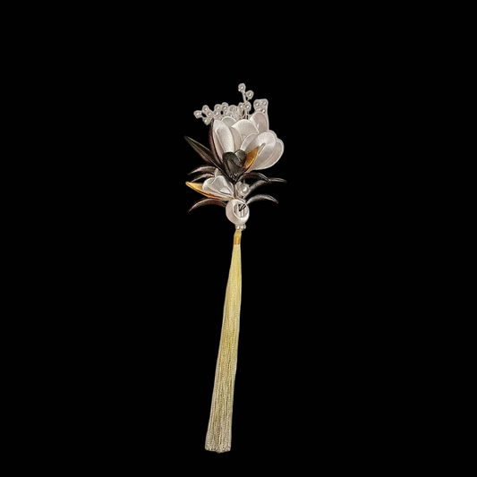 Handcrafted Chanhua thread-wrapped brooch with silver and black flowers, gold accents, and a long silky gold tassel on a white background.