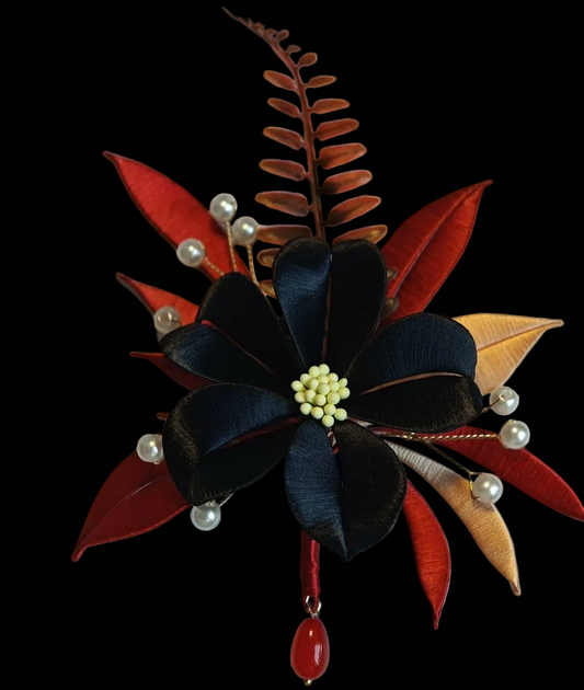 Handcrafted Chanhua brooch featuring thread-wrapped pink flowers, green leaves, and a red Double Happiness symbol.