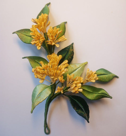 3D floral pin depicting blooming yellow Osmanthus blossoms made with traditional artisanal thread-wrapping.