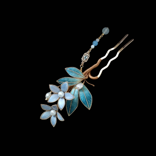 Close-up of Ronghua Liyou hairpin showing teal velvet leaves with gold edge trim and soft blue petals with pearl center detail