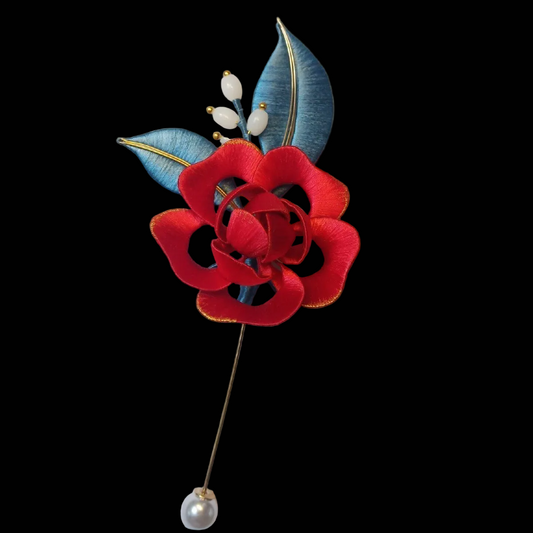 Handcrafted Chanhua red rose brooch featuring intricate thread-wrapped petals and green leaves.