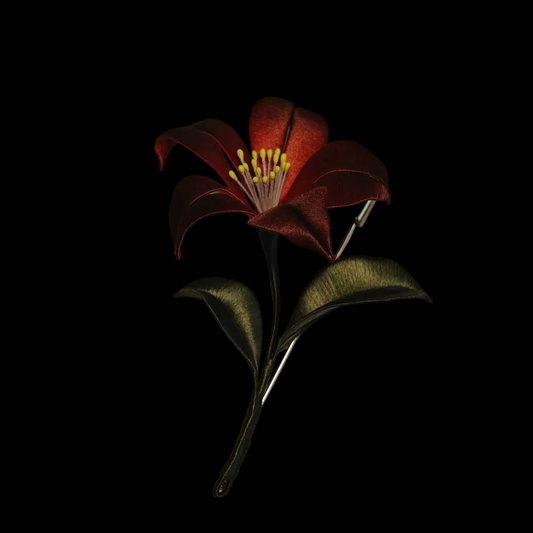 Handcrafted Chanhua Black Datura brooch featuring thread-wrapped black petals, dark red leaves, and a red bead drop.