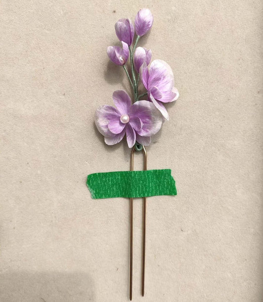 3D silk velvet flower hair accessory depicting a blooming purple orchid made with traditional artisanal Ronghua techniques on a U-shaped pin.