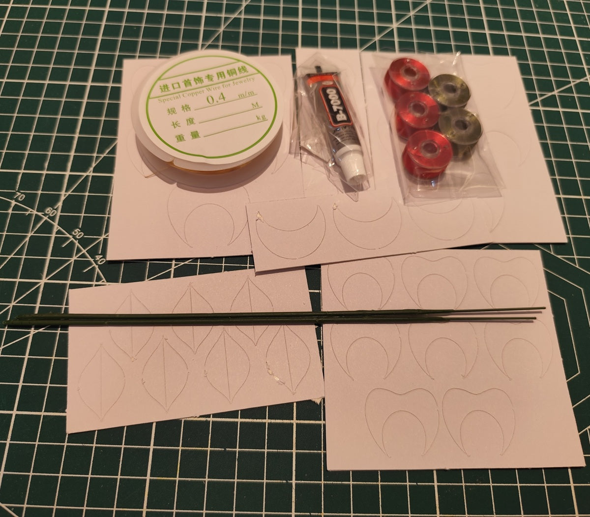 Contents of Blooming Rose Vase Display DIY Kit, including wire, glue, fabric petals, and stems.