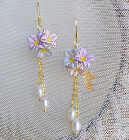 Exquisite lilac and white Chanhua flower drop earrings adorned with natural freshwater pearls, perfect for special occasions.