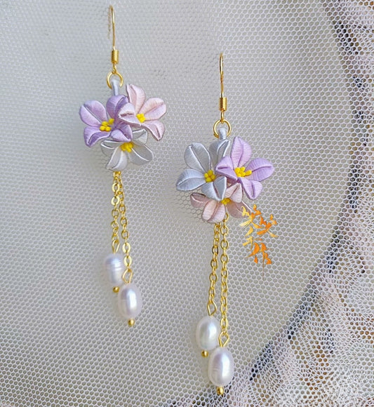 Exquisite lilac and white Chanhua flower drop earrings adorned with natural freshwater pearls, perfect for special occasions.