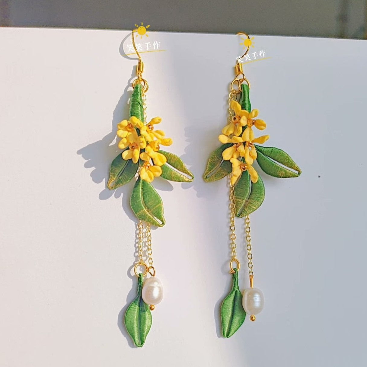 Elegant Chanhua floral earrings showcasing yellow osmanthus blossoms, green foliage, and natural pearl drops, handcrafted with 925 silver hooks.