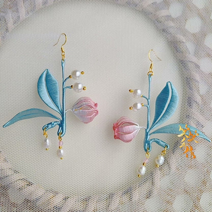 Pair of exquisite Chanhua embroidered earrings with delicate pink flowers and pearl accents, showcasing artisanal craftsmanship.
