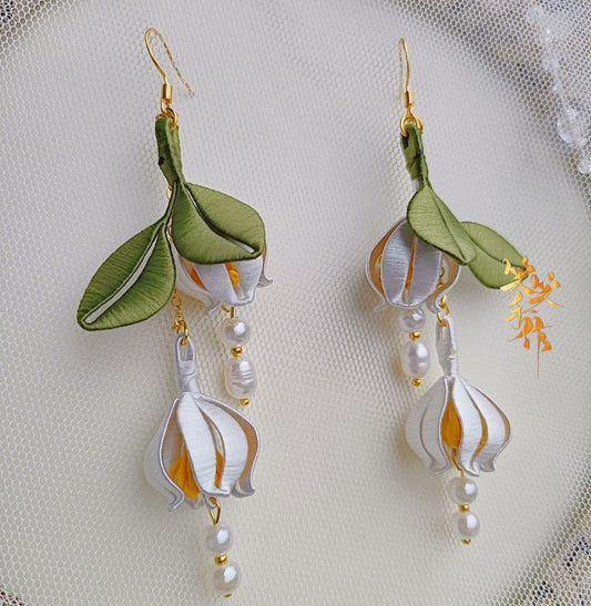 Handcrafted Chanhua flower drop earrings with white silk petals and natural freshwater pearls on 925 silver hooks, showcasing intricate detail for SEO.
