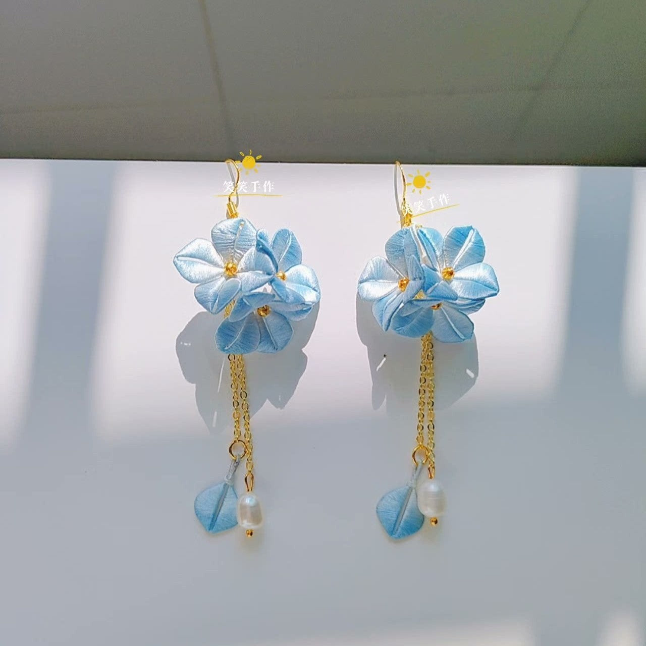 Elegant white Chanhua blossom earrings handmade with silk petals, 925 silver ear wires, and two lustrous freshwater pearls.