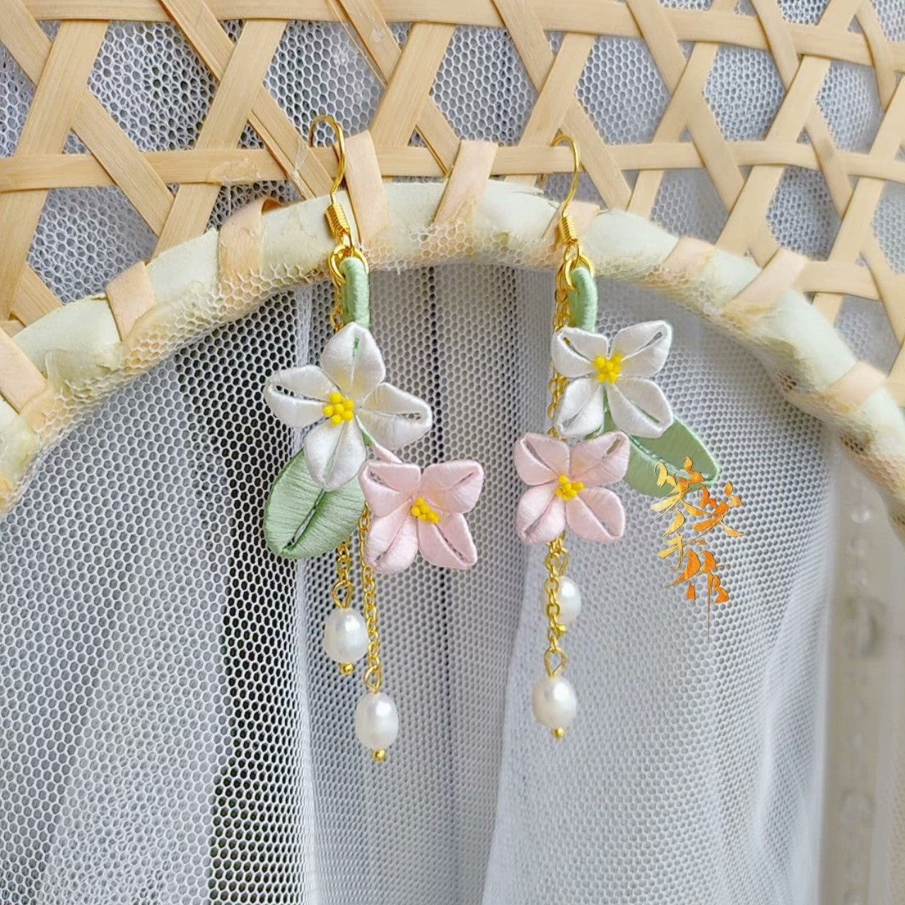 Close-up of a pair of artisan Chanhua floral earrings with 925 sterling silver hooks and natural freshwater pearls, displayed against a light background.