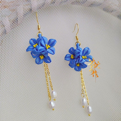 Elegant blue Chanhua flower earrings featuring genuine freshwater pearls, gold chains, and 925 sterling silver hooks.