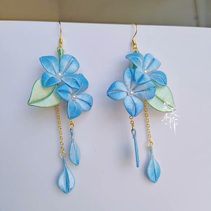 Beautiful artisan blue floral earrings with sterling silver hooks, showcasing intricate design and long dangle style for women.