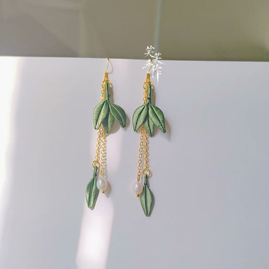 Handcrafted Chanhua embroidered green leaf and natural freshwater pearl drop earrings with 925 silver hooks, displayed against a white background.