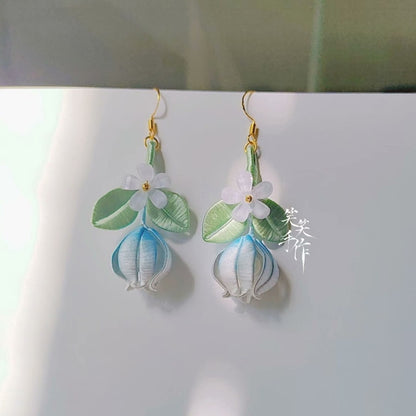Elegant studio shot of two handcrafted Chanhua earrings for women, showcasing their delicate artistry and ideal for everyday wear or special occasions, with a soft background.