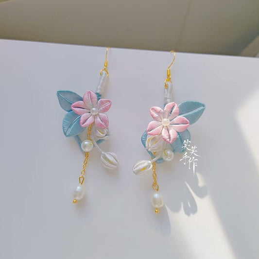 Handcrafted Chanhua flower dangle earrings with natural freshwater pearls and 925 silver hooks, front view.