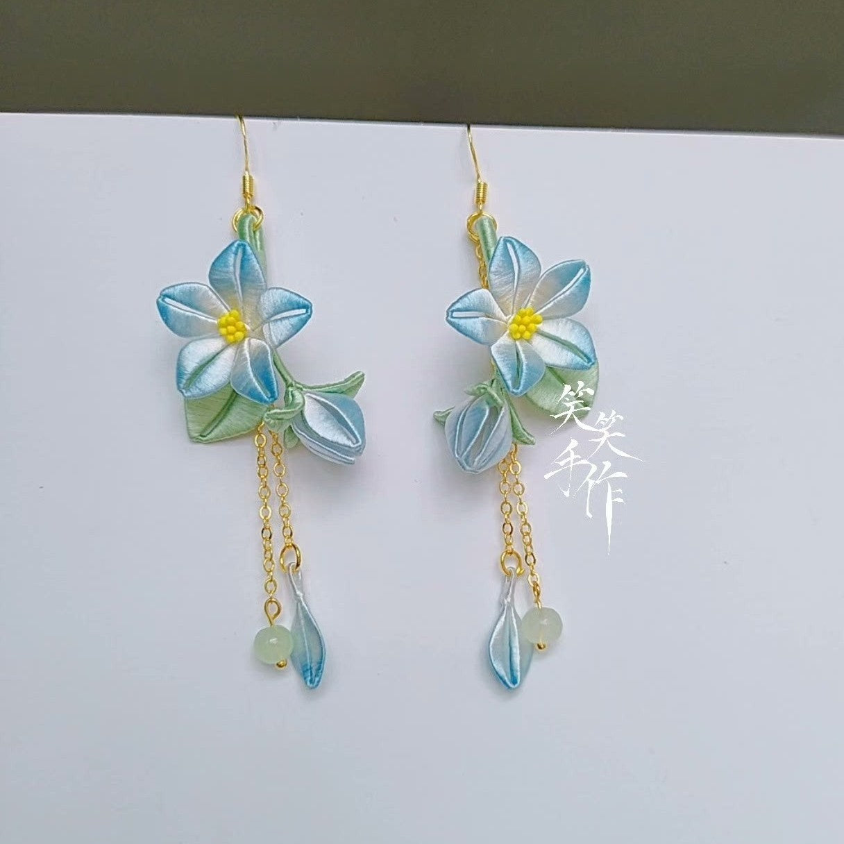 Detailed shot highlighting the artisanal quality of handcrafted Chanhua floral earrings, showcasing the delicate petals, bud design, and long dangle, suitable for both daily and formal wear.